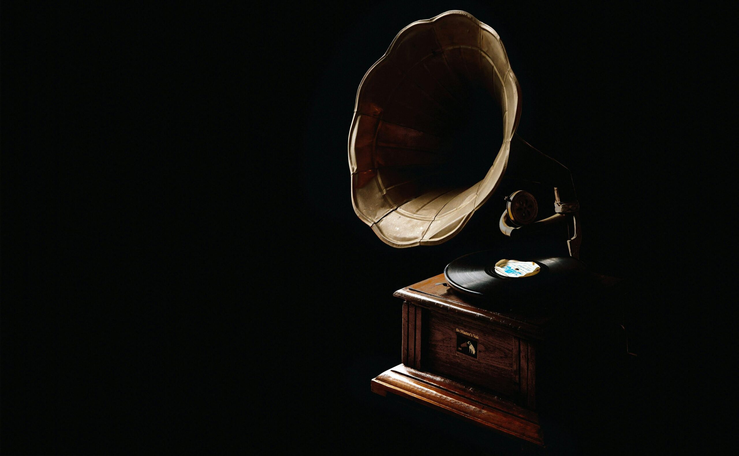 A classic gramophone with vinyl record, showcasing vintage charm in a dark ambiance.